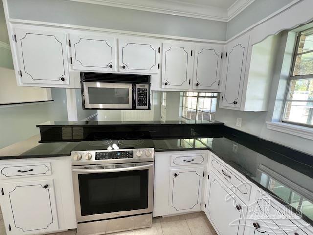 kitchen featuring white cabinetry, crown molding, and appliances with stainless steel finishes