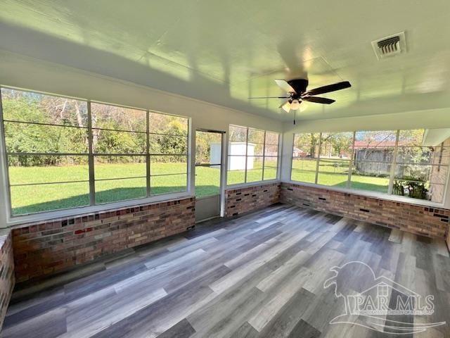 unfurnished sunroom featuring ceiling fan