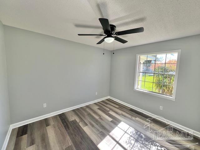 spare room with wood-type flooring, a textured ceiling, and ceiling fan