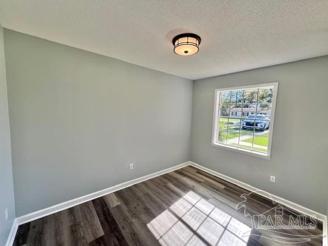 spare room with wood-type flooring and a textured ceiling