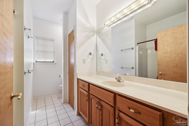 bathroom with tile patterned floors, vanity, and toilet