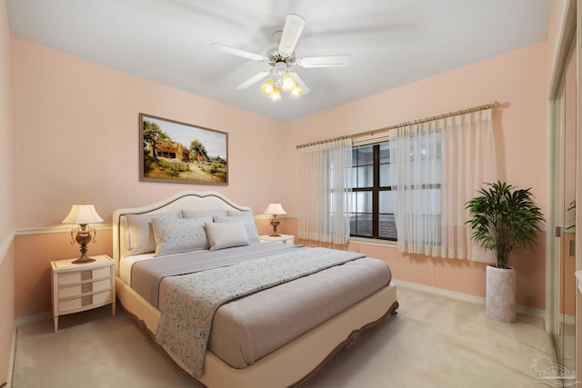 bedroom featuring ceiling fan and light carpet