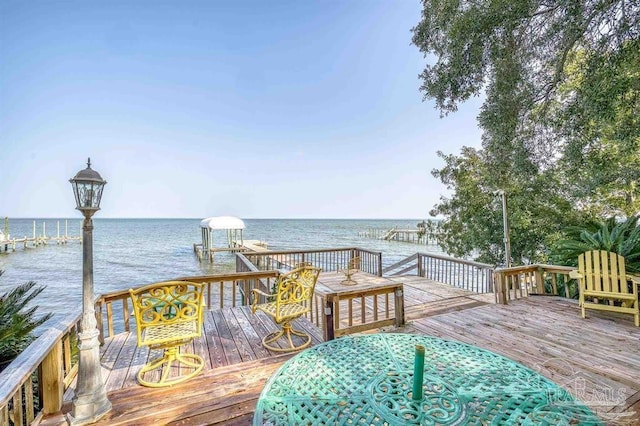 wooden terrace with a boat dock and a water view