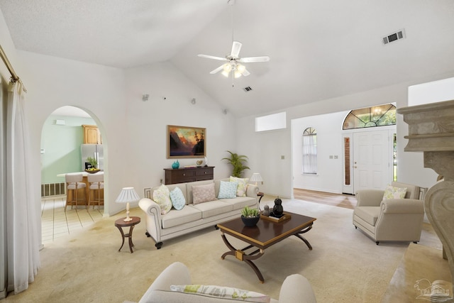 living room featuring ceiling fan, light carpet, and high vaulted ceiling