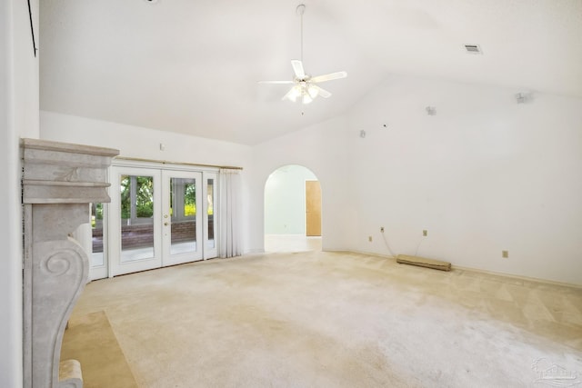 unfurnished living room with light carpet, french doors, ceiling fan, and vaulted ceiling