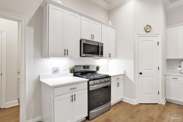 kitchen with stainless steel appliances and white cabinetry