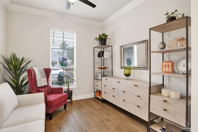 sitting room featuring hardwood / wood-style flooring, crown molding, and ceiling fan