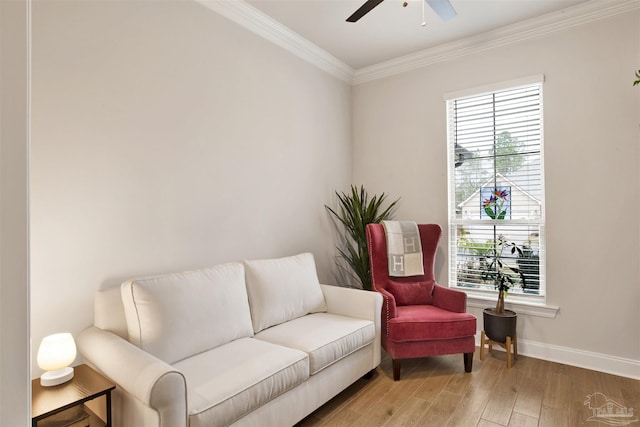 living area featuring crown molding, ceiling fan, and hardwood / wood-style floors