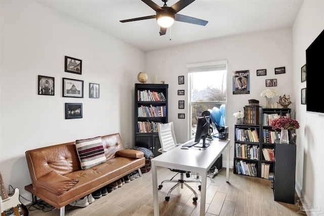 home office featuring light hardwood / wood-style flooring and ceiling fan