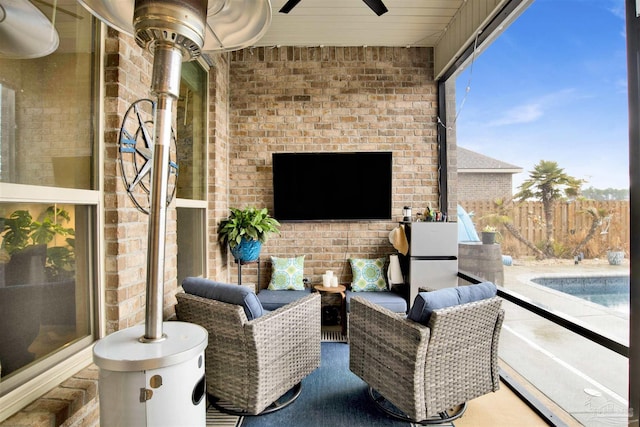 view of patio featuring a fenced in pool and ceiling fan