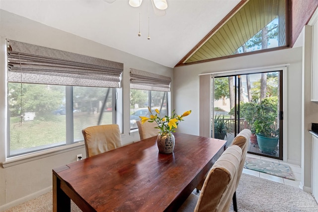 carpeted dining room featuring lofted ceiling, ceiling fan, and a wealth of natural light