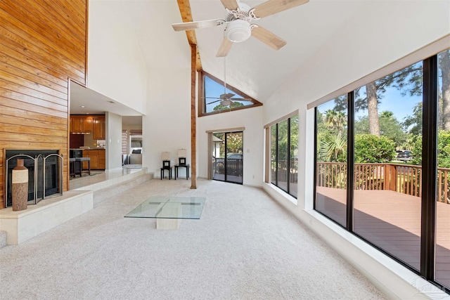 unfurnished sunroom with ceiling fan and vaulted ceiling