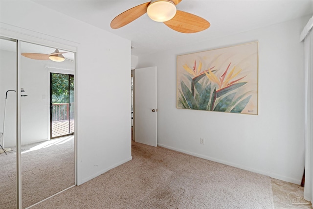 carpeted spare room with ceiling fan