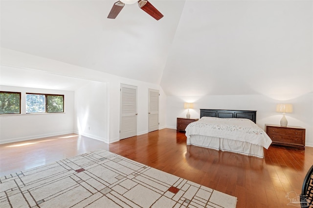 bedroom with lofted ceiling, dark hardwood / wood-style floors, and ceiling fan