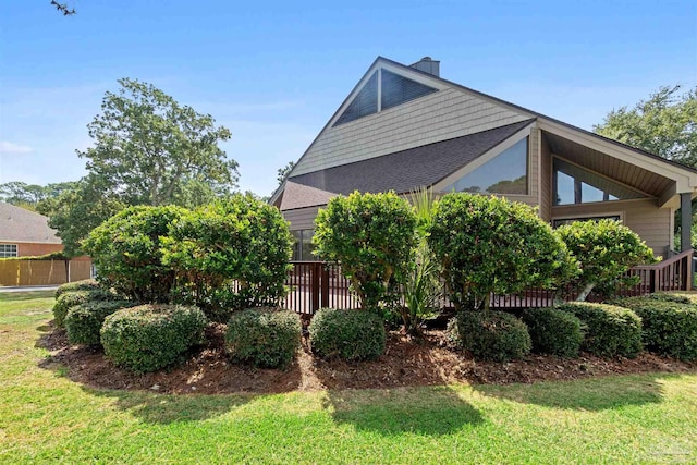 view of side of home with a lawn