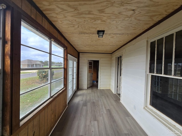 unfurnished sunroom featuring plenty of natural light and wooden ceiling