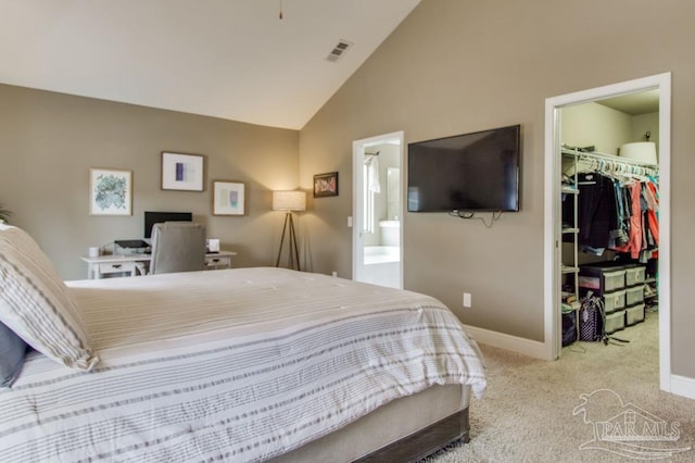 bedroom featuring visible vents, light colored carpet, lofted ceiling, a spacious closet, and a closet