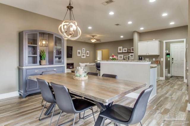 dining room with light wood-style floors, baseboards, visible vents, and recessed lighting