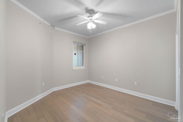 spare room featuring a textured ceiling, light wood-type flooring, ceiling fan, and crown molding