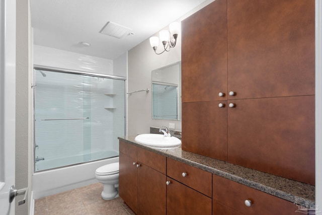 full bathroom with tile patterned flooring, vanity, toilet, and shower / bath combination with glass door