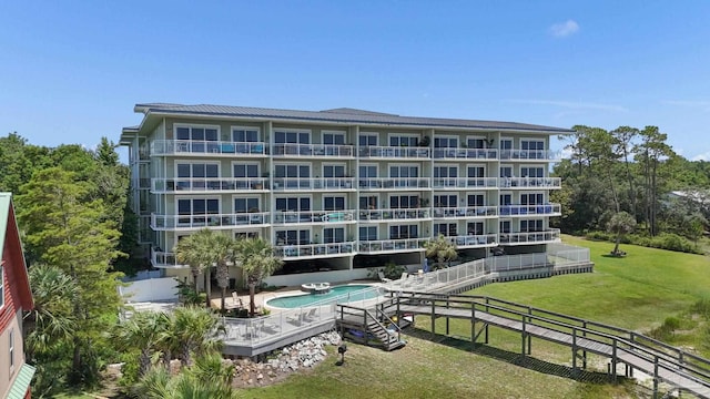 view of building exterior with a fenced in pool