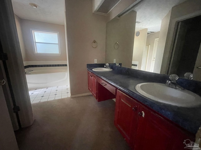 bathroom with vanity, tile patterned flooring, and a bathing tub