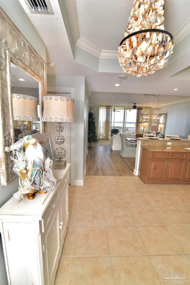 645 Lost Key Dr Unit 406D, Perdido Key, FL 32507 - interior space with a raised ceiling, visible vents, light tile patterned floors, crown molding, and a textured ceiling