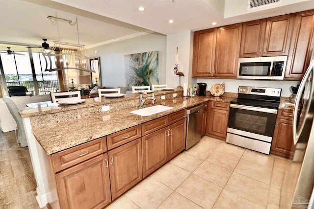 645 Lost Key Dr Unit 406D, Perdido Key, FL 32507 - kitchen with a sink, ceiling fan, stainless steel appliances, a peninsula, and light stone countertops