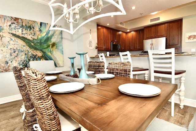645 Lost Key Dr Unit 406D, Perdido Key, FL 32507 - dining room with baseboards, an inviting chandelier, recessed lighting, visible vents, and light wood finished floors