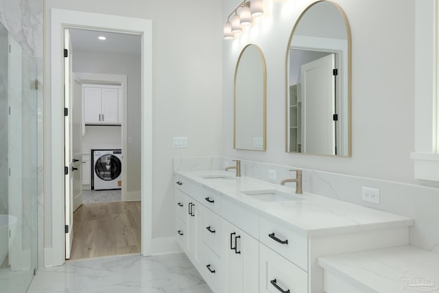 bathroom featuring washer / clothes dryer and vanity