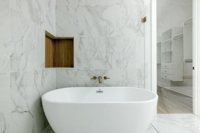 bathroom with a tub to relax in