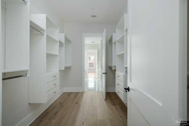 spacious closet featuring light hardwood / wood-style floors