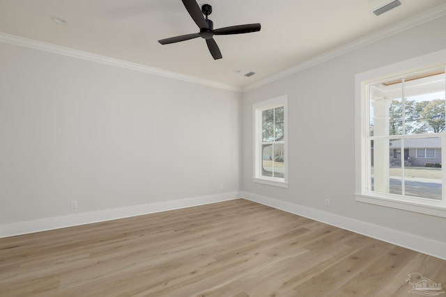 spare room with ornamental molding, a wealth of natural light, ceiling fan, and light hardwood / wood-style flooring