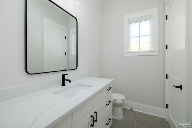 bathroom featuring vanity, tile patterned floors, and toilet