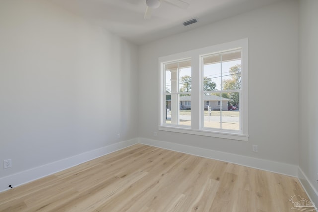 spare room with ceiling fan and light wood-type flooring