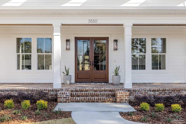 property entrance featuring french doors and a porch