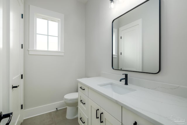 bathroom featuring vanity, toilet, and tile patterned flooring