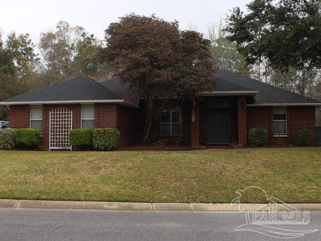 single story home with brick siding and a front yard