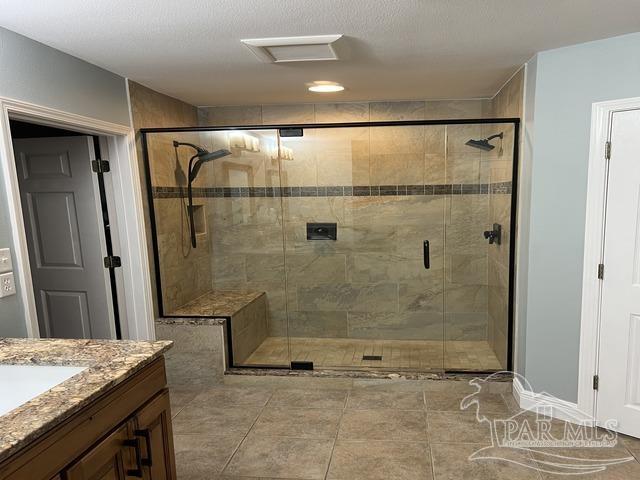 full bathroom featuring a stall shower and vanity