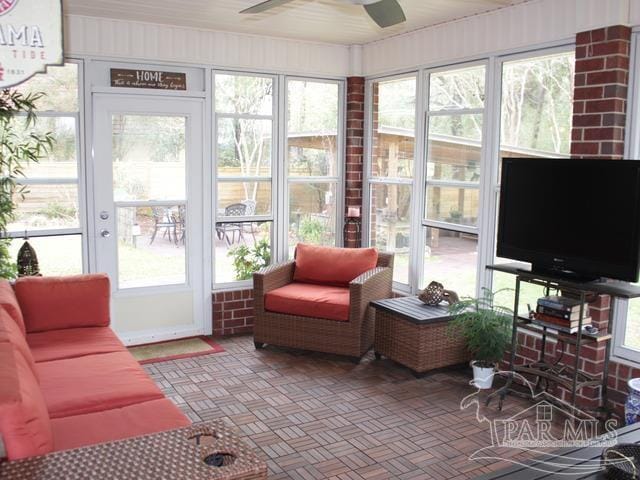 sunroom featuring ceiling fan