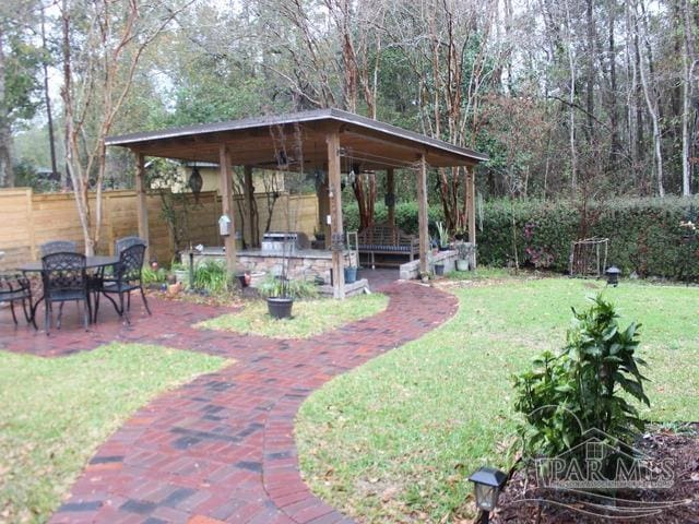 view of yard featuring a patio area, fence, and a gazebo