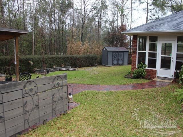 view of yard featuring a storage shed and an outdoor structure