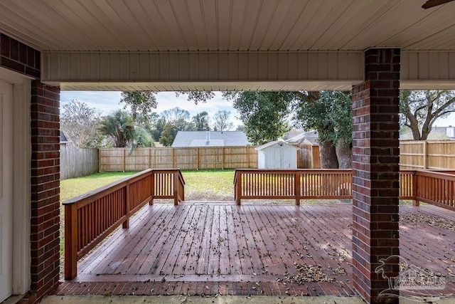 wooden terrace with a shed