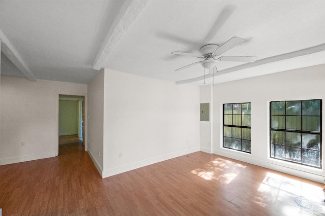 spare room featuring beam ceiling, electric panel, ceiling fan, and wood-type flooring