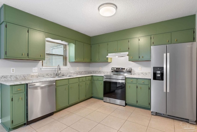 kitchen with appliances with stainless steel finishes, a textured ceiling, light tile patterned floors, and sink