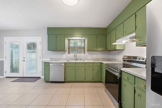 kitchen featuring sink, french doors, stainless steel appliances, a textured ceiling, and light tile patterned floors