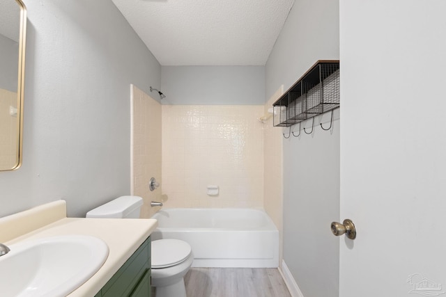 full bathroom featuring vanity, shower / tub combination, toilet, a textured ceiling, and wood-type flooring