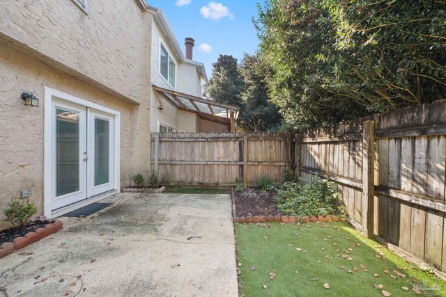 view of yard with a patio and french doors