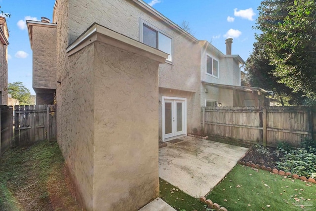 back of property featuring french doors and a patio