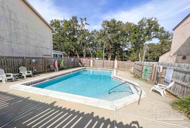 view of swimming pool with a patio area